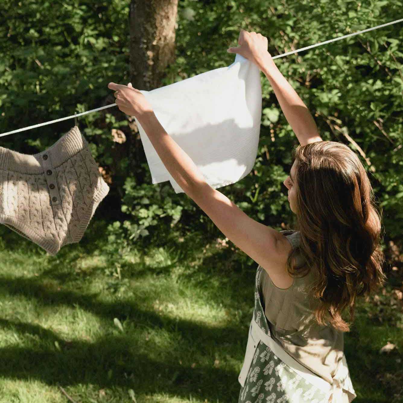 woman hanging washing on the line outdoors