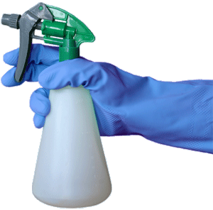gloved hand holding bottle of cleaning spray